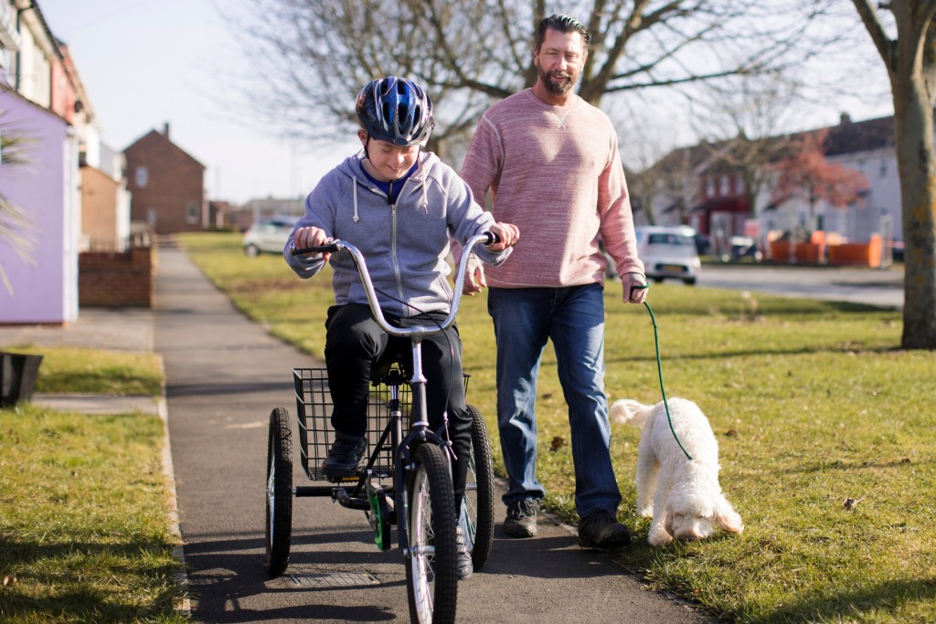 An NDIS participant is learning to ride a bike as part of their physiotherapy rehabilitation.