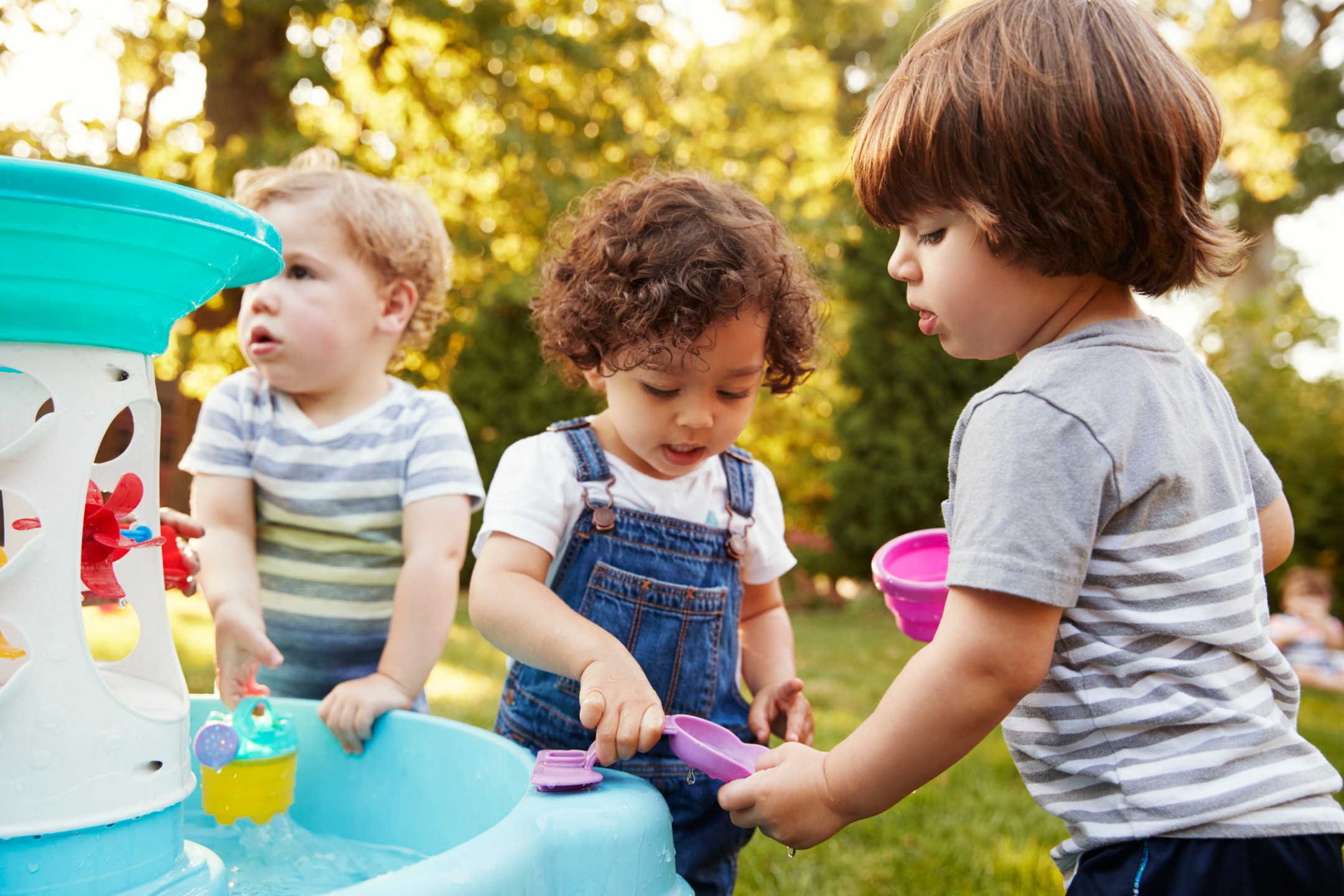 Children engaged in play-based activities under a key worker model therapy session.